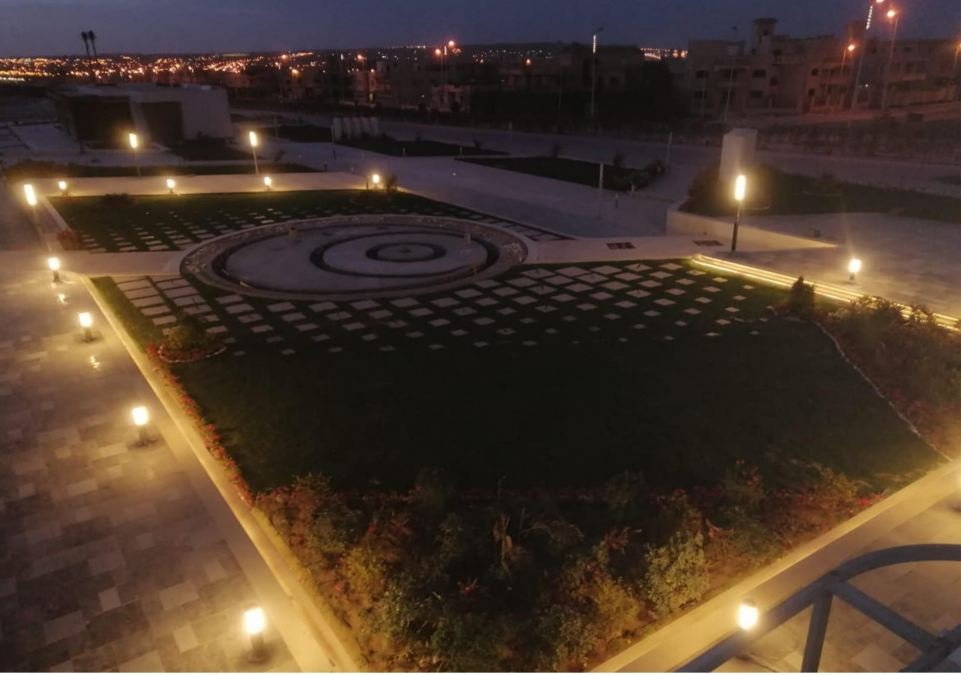 Landscaped plaza lit at night, a completed Target infrastructure project